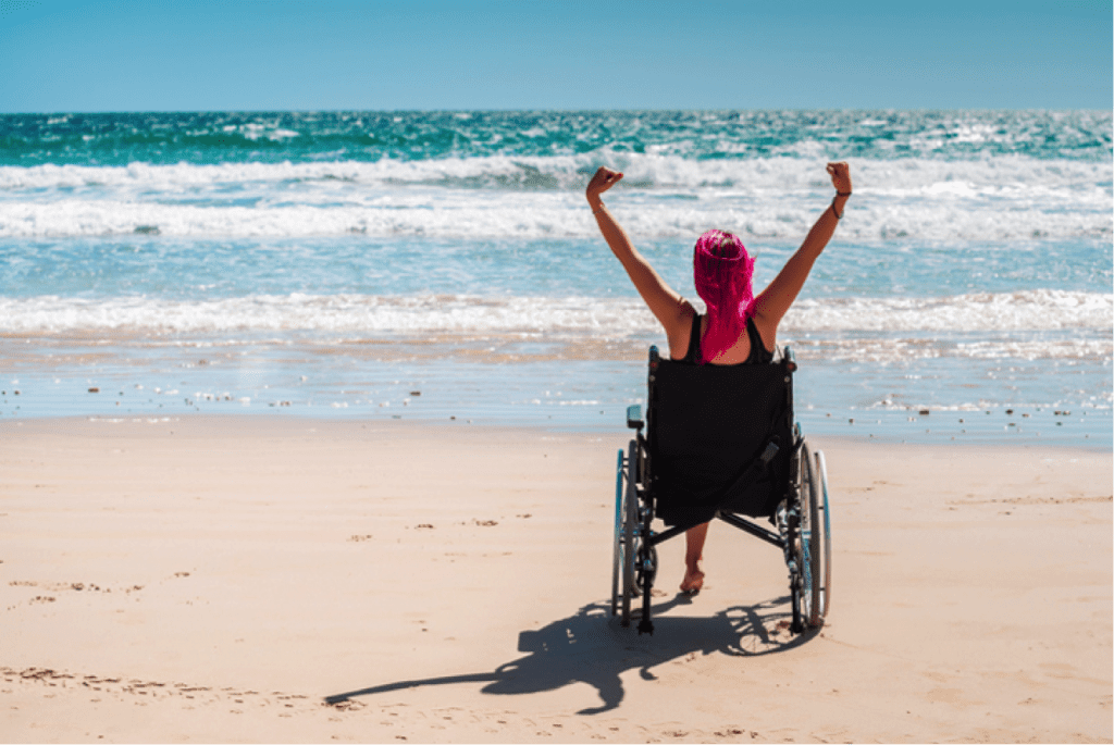 Woman in wheelchair on the beach