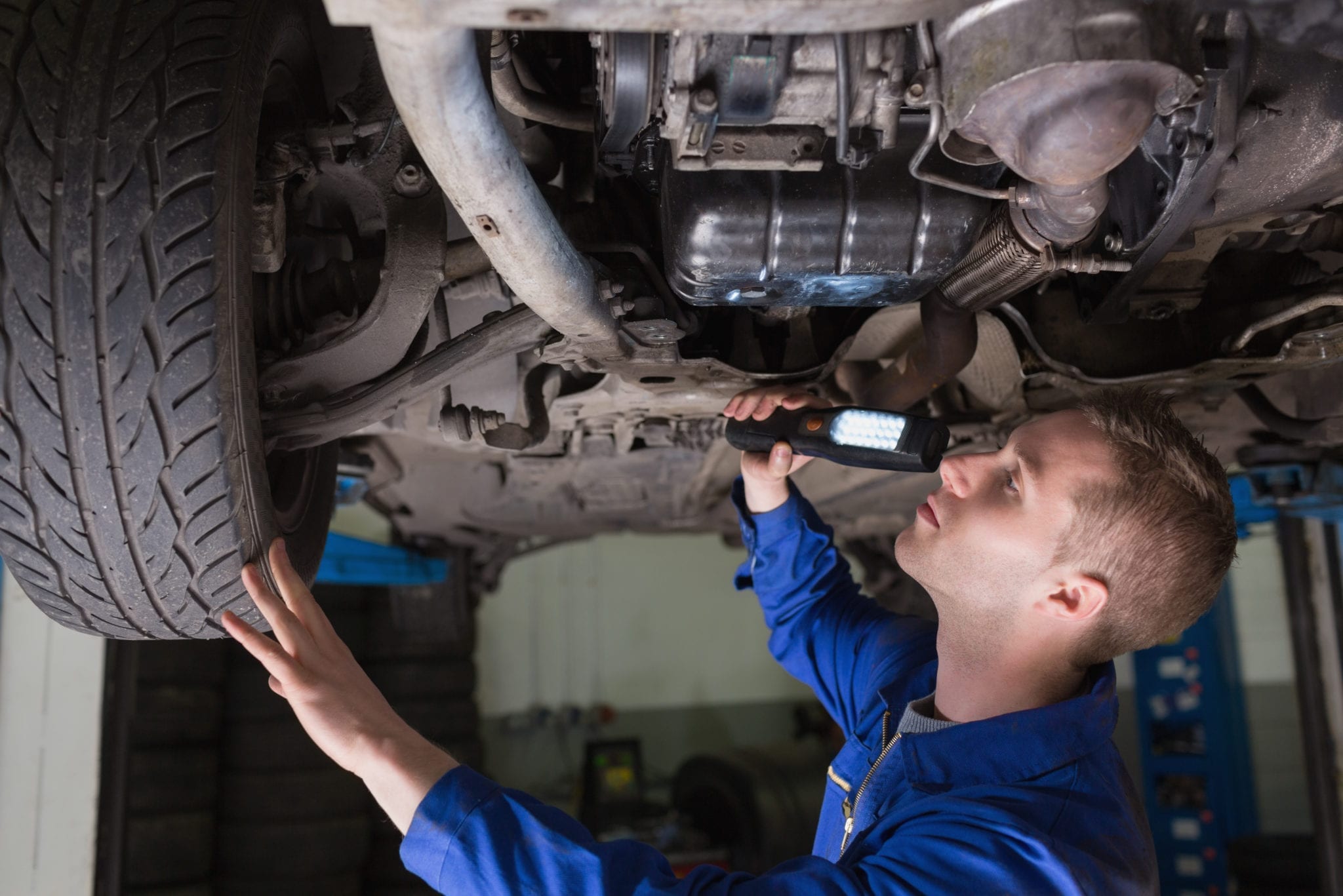 A man working on the underside of a van